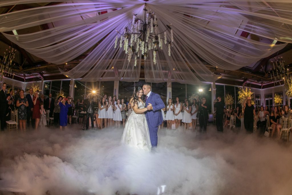 daughter and father dancing on smoke clouds at her sweet 16