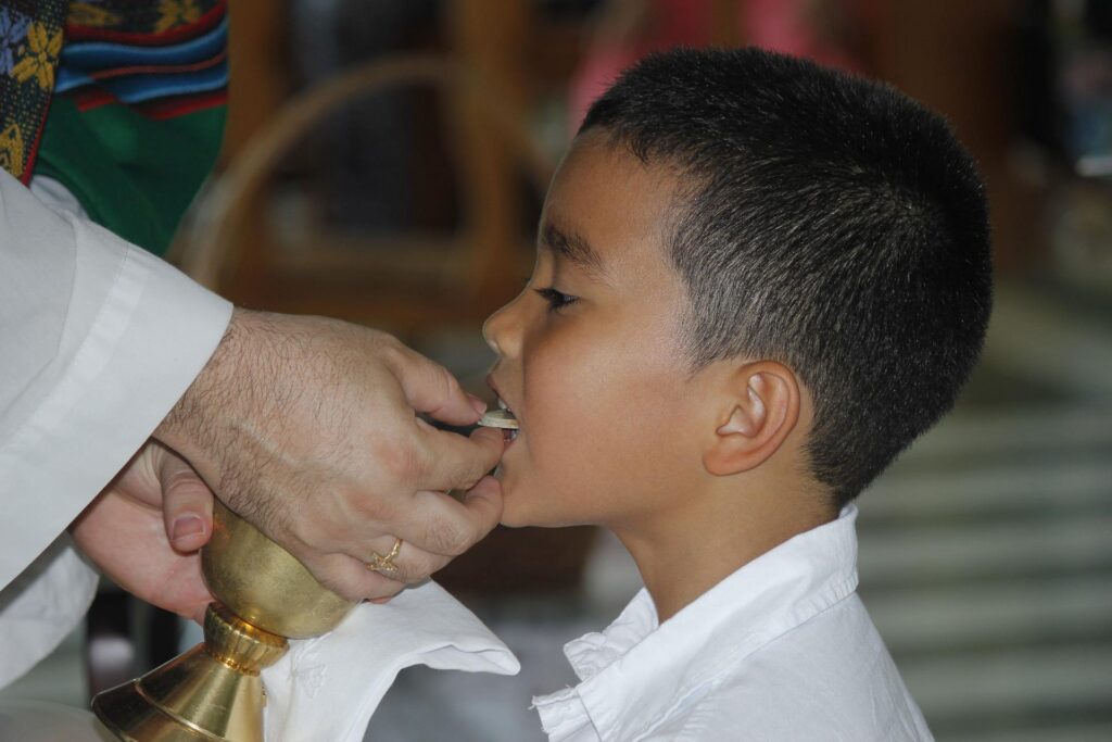 boy receiving  first communion