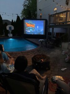 Backyard outdoor movie screen rental at night