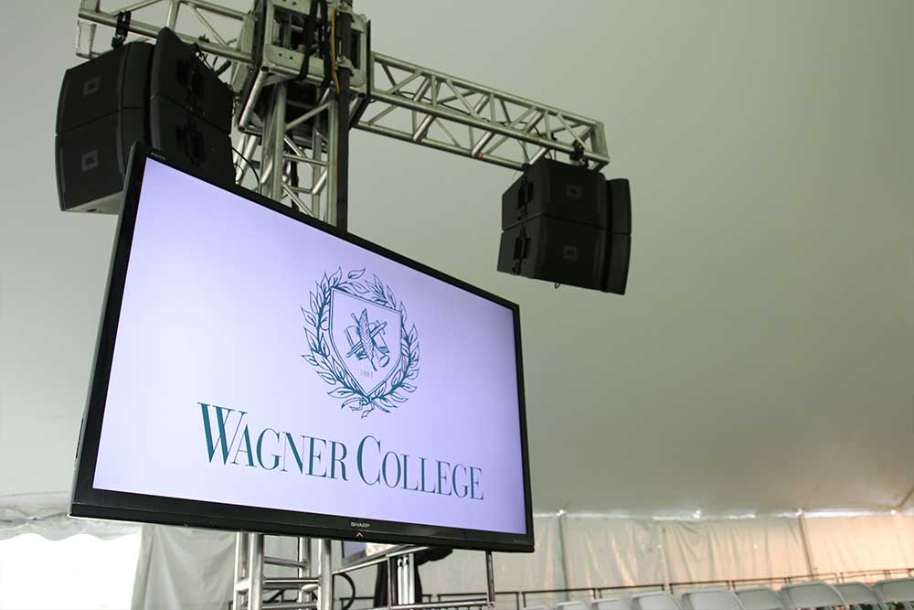 Outdoor Graduation And Commencement Ceremonies with School logo on screen